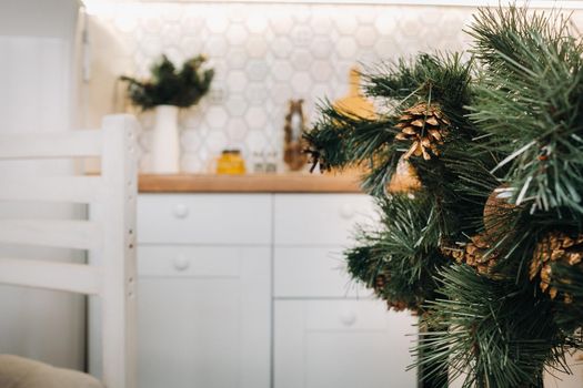 Christmas table decoration in the kitchen, Banquet table with glasses before serving food, close-up of the Christmas dinner table with seasonal decorations, crystal glasses and decorative deer.