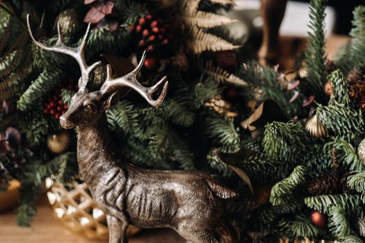 Christmas table decoration, Banquet table with glasses before serving food, Close-up of Christmas dinner table with seasonal decorations, crystal glasses and decorative deer.