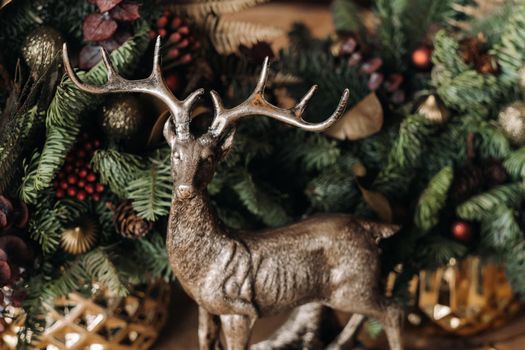 Christmas table decoration, Banquet table with glasses before serving food, Close-up of Christmas dinner table with seasonal decorations, crystal glasses and decorative deer.