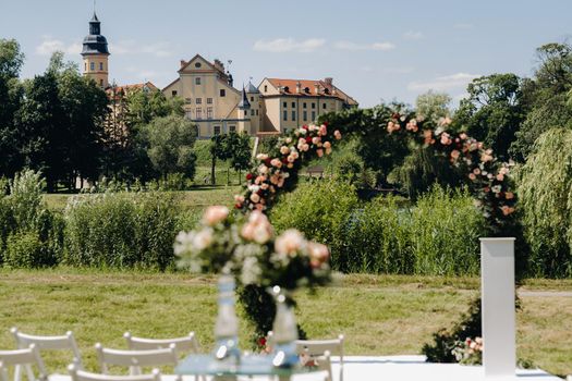 Wedding ceremony on the street on the green lawn near the Nesvizh Castle.Belarus.