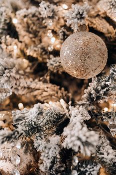 Christmas tree close-up. On New year's eve, a decorated snow-covered Christmas tree