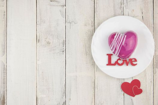 word love with red cake in the shape of a heart is on the white wood table. Romantic date. breakfast. Birthday. Wedding. Holiday. Top view