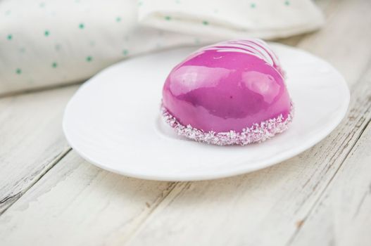 Red cake in the shape of a heart is on the table. Romantic date