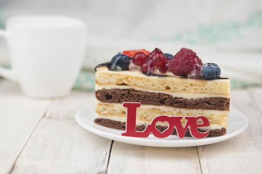 Mix berry colorful slice cake on white plate on wood background