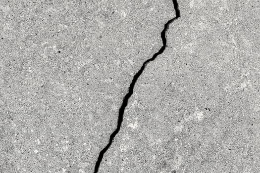 Cracked texture of gray concrete. Abstract background for design.