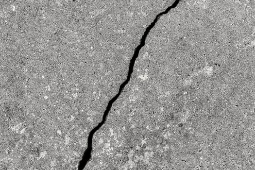 Cracked texture of gray concrete. Abstract background for design.