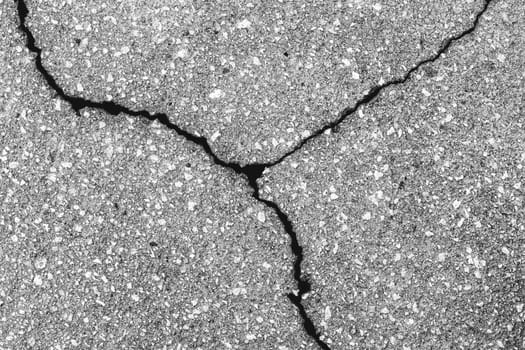 Cracked texture of gray asphalt. Abstract background for design.