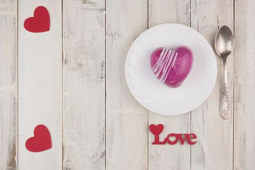 word love with red cake in the shape of a heart is on the white wood table. Romantic date. breakfast. Birthday. Wedding. Holiday. Top view