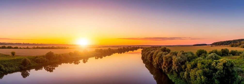 A sunset or sunrise scene over a lake or river with skies reflecting in the water on a summer evening or morning. Landscape.