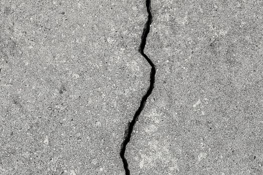 Cracked texture of gray concrete. Abstract background for design.