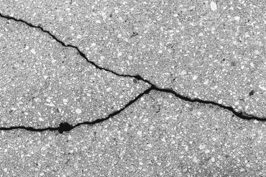 Cracked texture of gray asphalt. Abstract background for design.