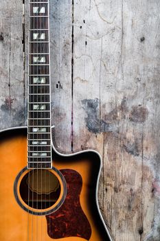 Detail of Acoustic Guitar on a wood background