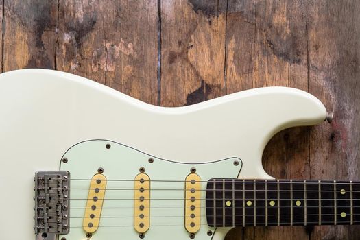 Detail of Acoustic Guitar on a wood background