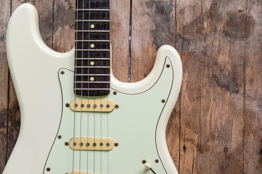 Detail of Acoustic Guitar on a wood background