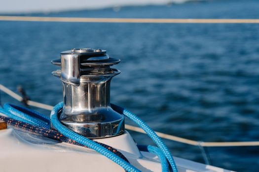 rope on the winch of a white yacht in the sea.yacht equipment.