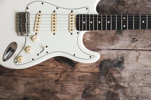 Detail of Acoustic Guitar on a wood background