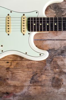 Detail of Acoustic Guitar on a wood background