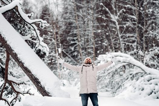 A tourist walks in a snow-covered forest. Winter forest in Estonia.Journey through the winter forest.