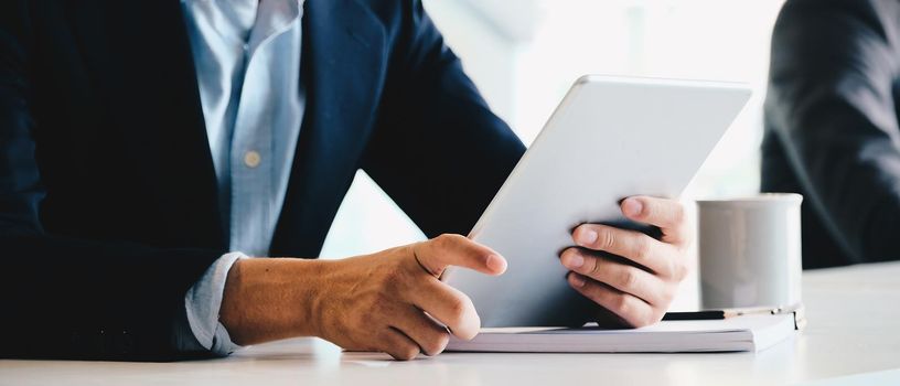 Close up businessman using digital tablet computer.