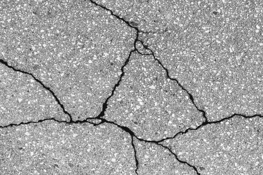 Cracked texture of gray asphalt. Abstract background for design.