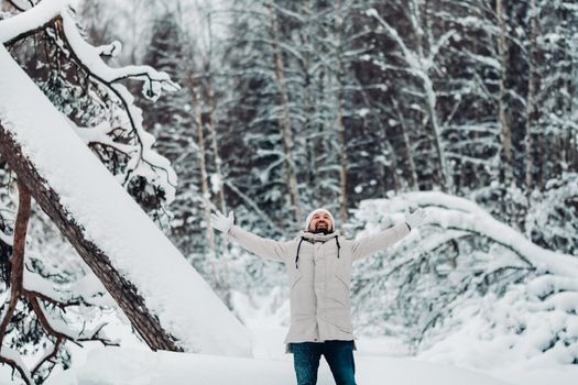 A tourist walks in a snow-covered forest. Winter forest in Estonia.Journey through the winter forest.