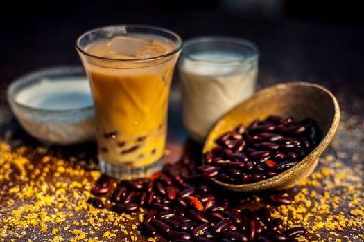 Red bean or kidney bean smoothie in a glass along with some red bean paste, banana, yogurt, milk, and oatmeal. Horizontal shot.