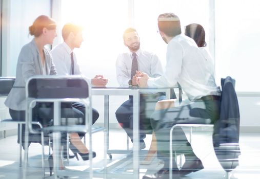 through the glass.the business team is holding a meeting. the concept of teamwork