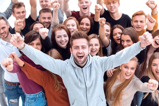 close up. handsome confident guy standing among his friends