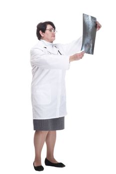 in full growth. older woman is a medic with an x-ray in her hands. isolated on a white background.