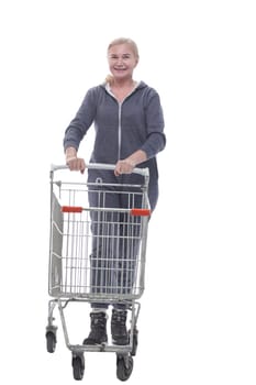 in full growth. smiling woman in casual clothes with shopping cart . isolated on a white background