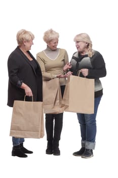 in full growth. three happy women with shopping bags. isolated on a white background.