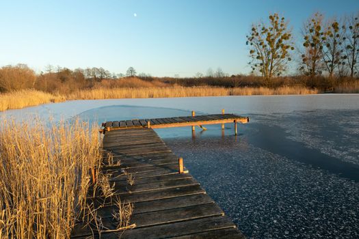 A wooden pier and a frozen lake in eastern Poland, Stankow, Lubelskie