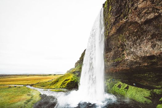 Side view of Gljufrafoss, or Gljufrabui, waterfall, a small waterfall hidden on a narrow canyon near the more famous Seljalandsfoss, southern Iceland. High quality photo.