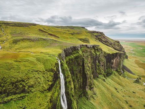 Iceland waterfall nature travel landscape in Icelandic nature background. Popular tourist attraction summer holiday destination in on South Iceland. High quality photo