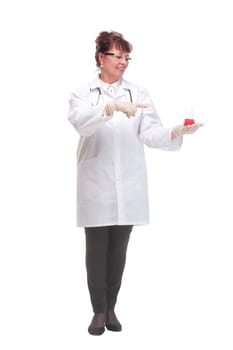 Front view of mature woman doctor or scientist holding the red fluid in beaker and pointing finger to it