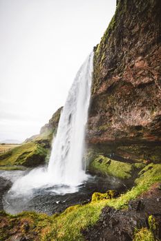 Gljufrafoss, or Gljufrabui, waterfall, a small waterfall hidden on a narrow canyon near the more famous Seljalandsfoss, southern Iceland. High quality photo.