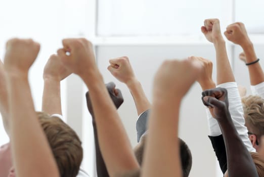 cropped image of a youth group pointing up. photo with copy space