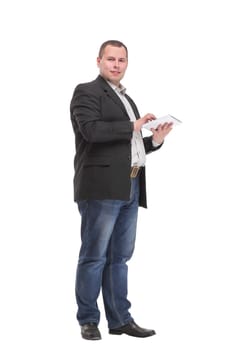 Side view of smiling business man using his tablet computer against a white background