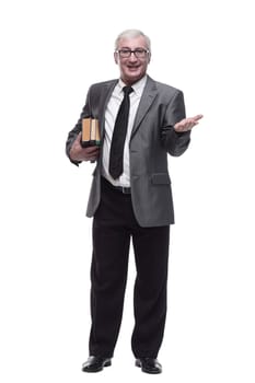 in full growth. smiling business man with a stack of books. isolated on a white background.