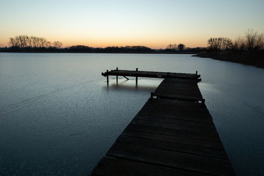 Wooden pier and a frozen lake, Stankow, Lubelskie, Poland