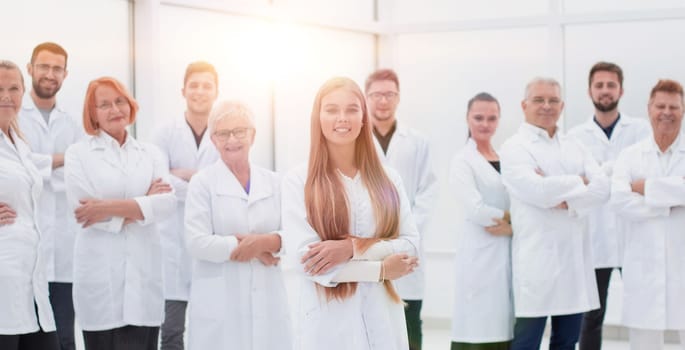 young researcher standing in front of her senior colleagues. concept of health protection.