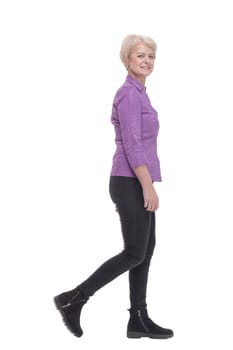 full-length. mature woman in purple blouse striding forward. isolated on a white background.