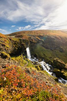 Sheep's Waterfall. Famous tourist landscape. Travel concept background. Dramatic autumn sun, Iceland, Atlantic Ocean, Europe. Travel postcard. High quality photo