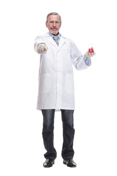 Mature scientist with grey hair and beard in white coat standing with beaker in his hand and holding medical test isolated on white background