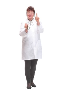 Mature woman doctor with stethoscope in ears and checking listening heart pulse pose, studio white background copy space