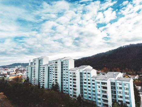 Aerial view, drone shoot, residential buildings on the outskirts of the city of Celje in Slovenia, some older and newer looking residential buildings.