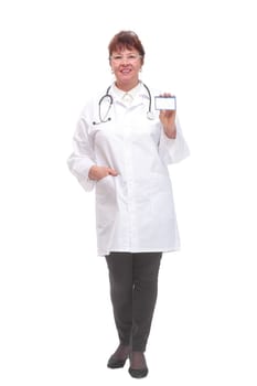 Senior woman doctor showing business card on a white background and looking at camera