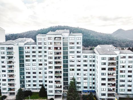 Aerial view, drone shoot, residential buildings on the outskirts of the city of Celje in Slovenia, some older and newer looking residential buildings.