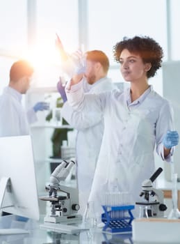 Team of Scientists Working Using Microscope, Analysing Microbiology Samples