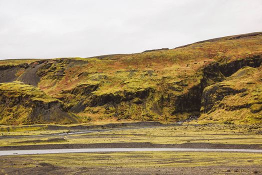 Green hills of Iceland, glacier land. Autumn time, cloudy days. Cold weather, hiking, tourist attractions.